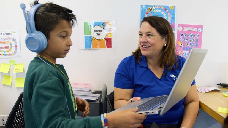 Christie Ray and a student learning at Alpha Austin.