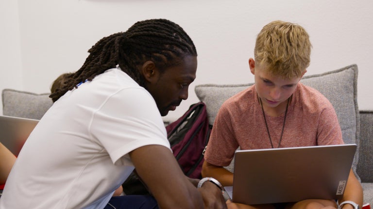 Greg helps a student with 2 Hour Learning.
