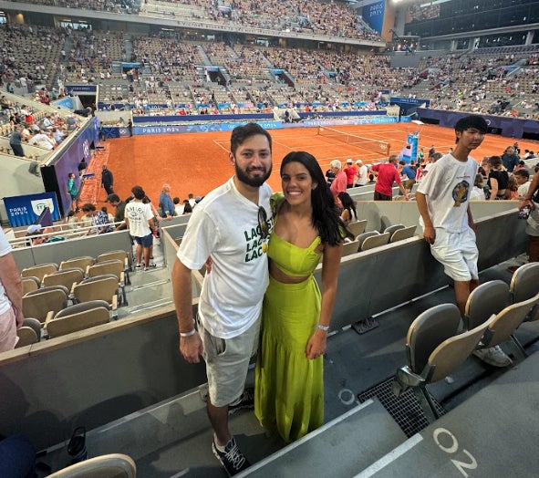 Jose Monteiro watching events at the Olympics with his wife.