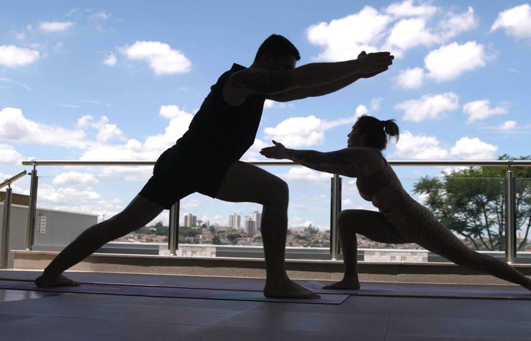 Gui doing yoga with his wife in his new house. 