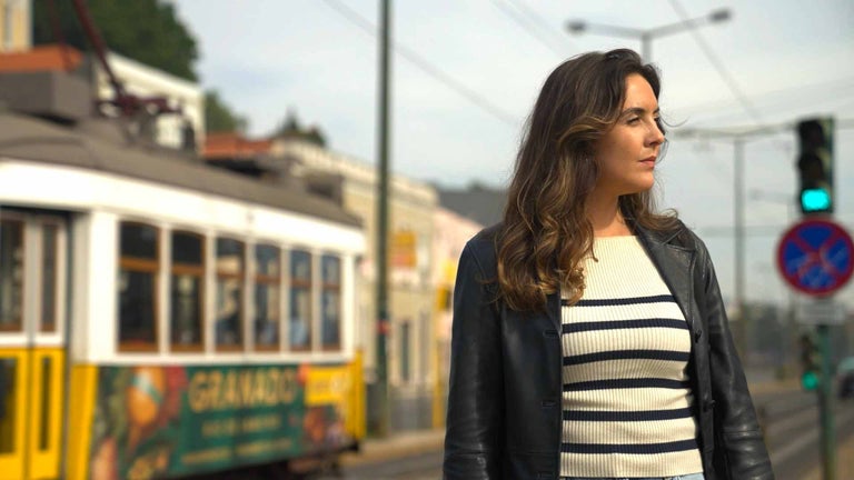 Regina enjoying remote work flexibility in Lisbon.