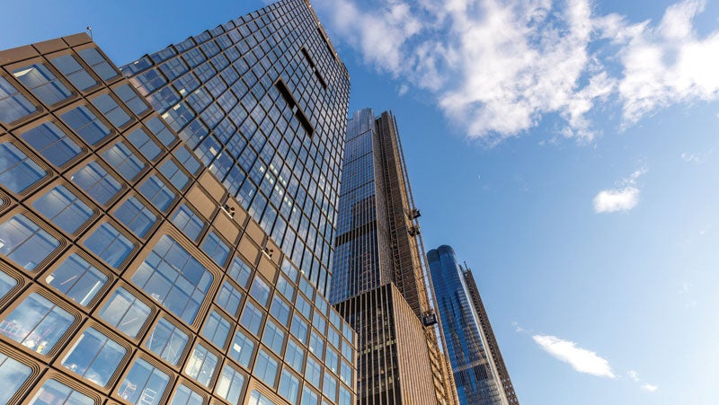 Skyscraper with brown extrusions protected by PPG CORAFLON® Platinum, powder coatings that meet AAMA 2065 specifications.