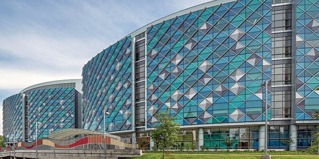 Exterior of Nemours Hospital for Children in Wilmington, Delaware, showing the building’s signature blue and green, glass and metal façade.