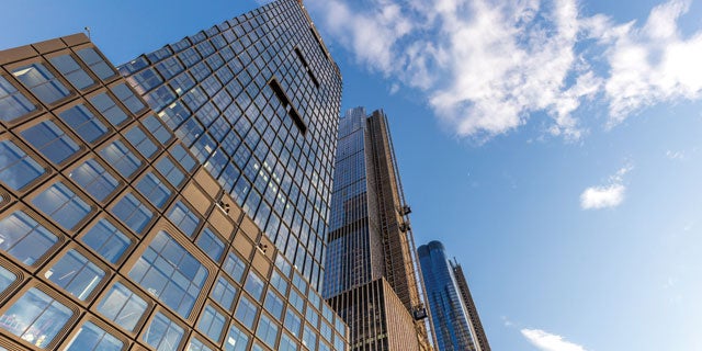 Skyscraper with brown extrusions protected by PPG CORAFLON® Platinum, powder coatings that meet AAMA 2065 specifications.