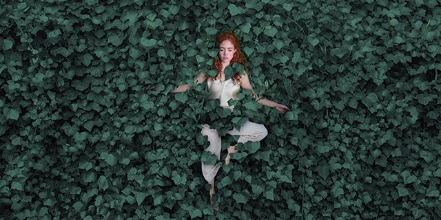 Girl surrounded by Vining Ivy