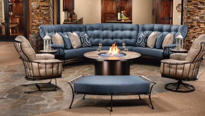 Large blue and beige outdoor furniture set around a fire, protected by PPG powder coatings for ultimate corrosion resistance.