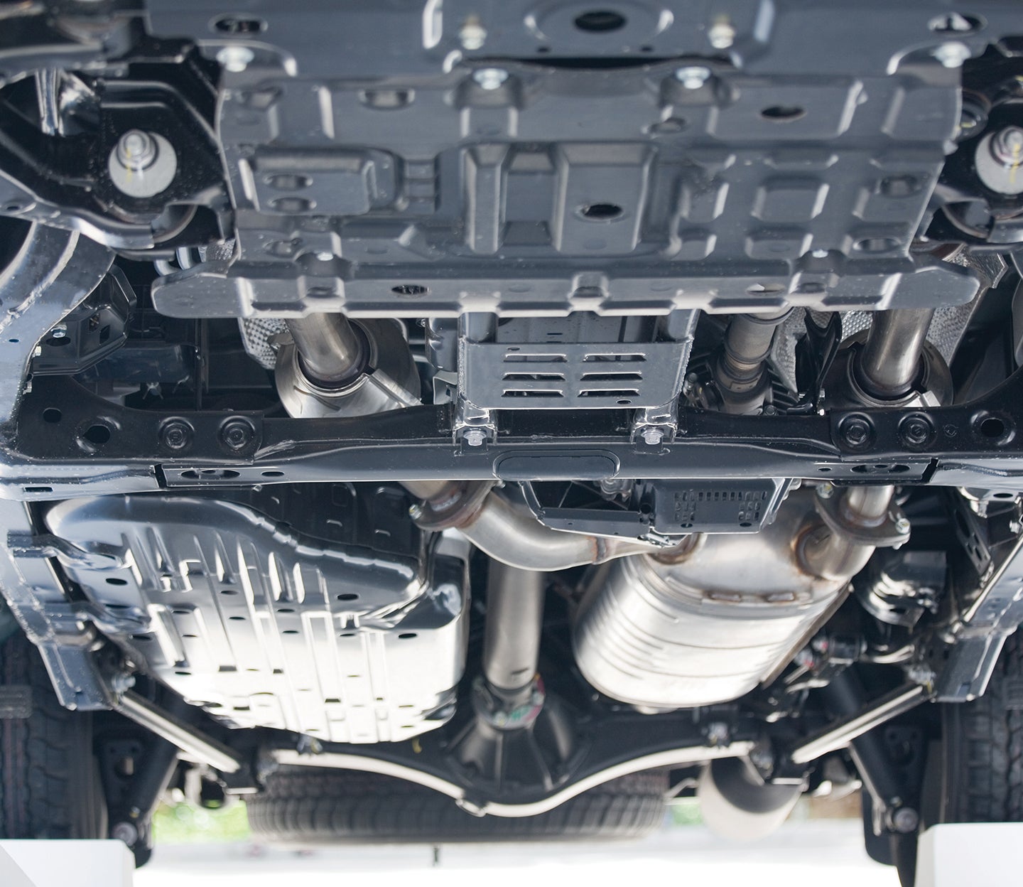 A close-up of the underneath of a car showing the different metal elements and parts coated by PPG Powercron epoxy electrocoats.