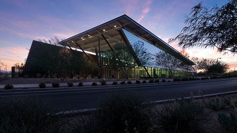 Exterior of the Appaloosa Branch Library showing the building's unique angled and split shape with the sunset to coming through the middle.