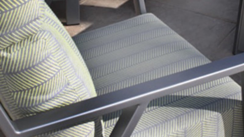 Grey and yellow outdoor chair with durable metal frame coated with PPG’s low-VOC Envirocron HTE powder coatings.