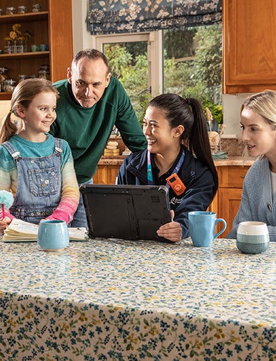 Service engineer in kitchen with family