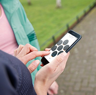 Ladies running, checking Hive on smartphone