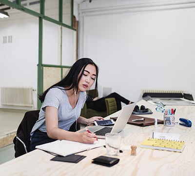 Woman working on a laptop at a desk