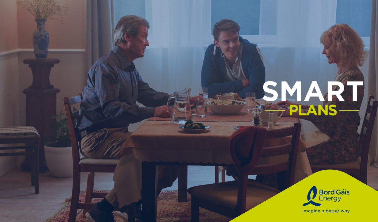 Family sitting around a table with Smart Plans logo