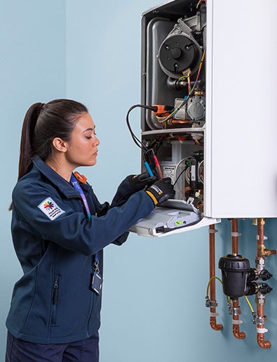 Service engineer fixing a boiler.