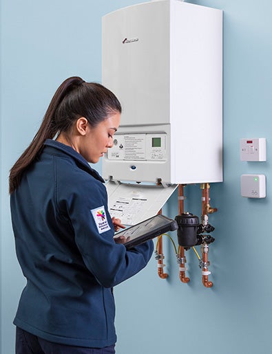 Service engineer monitoring a gas boiler.
