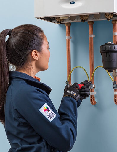 Service engineer fixing boiler.