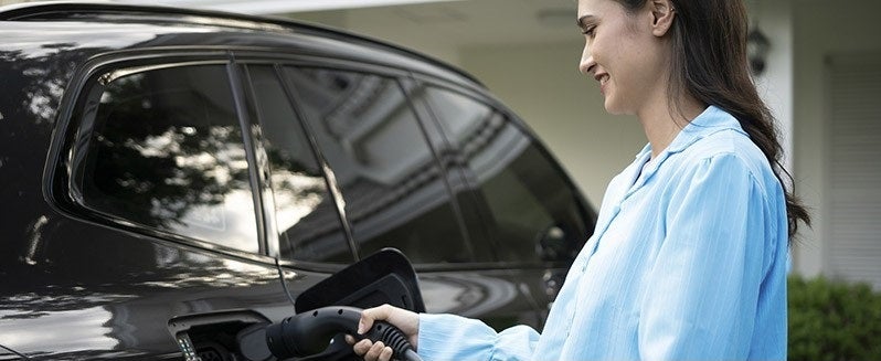 Woman charging EV
