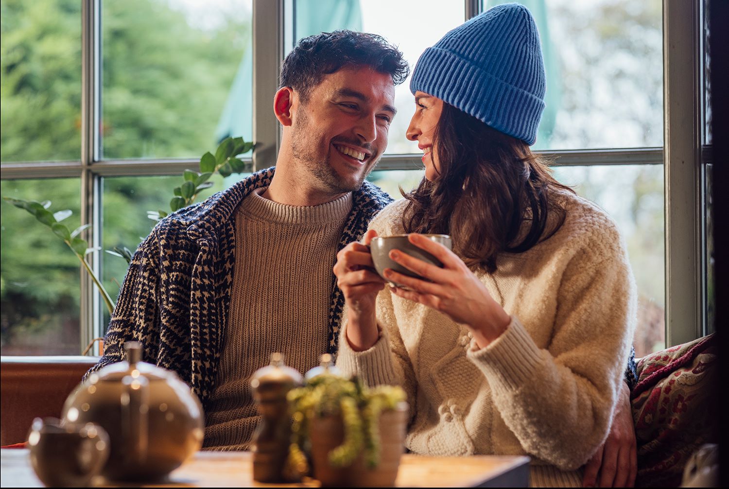 Man and woman laughing while having coffee