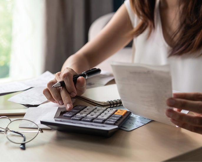 Woman using calculator