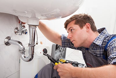 Plumber fixing tap
