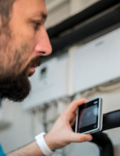 Service engineer servicing a heat pump.