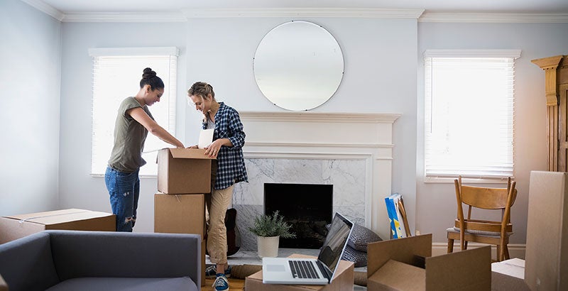 Couple unpacking moving boxes