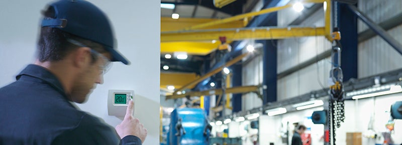 Man turning down thermostat at work