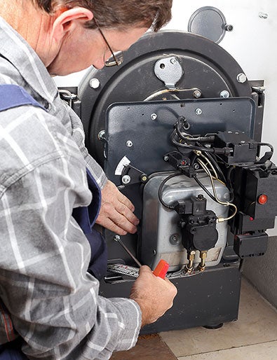 Engineer fixing oil boiler