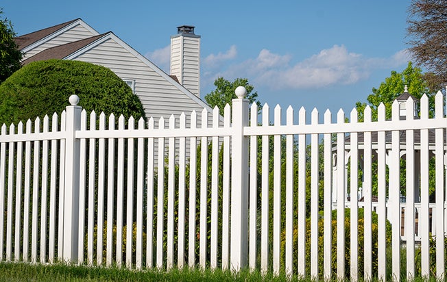 a white picket fence outside a home
