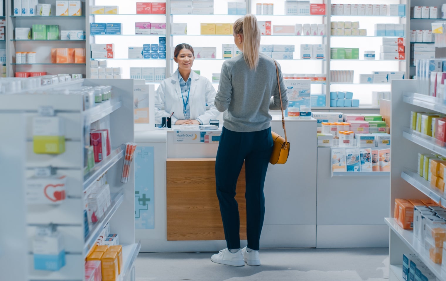 woman getting perscriptions at a pharmacy