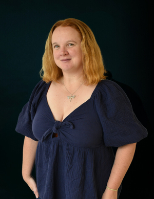 Picture of Jessica Goode standing against a black background