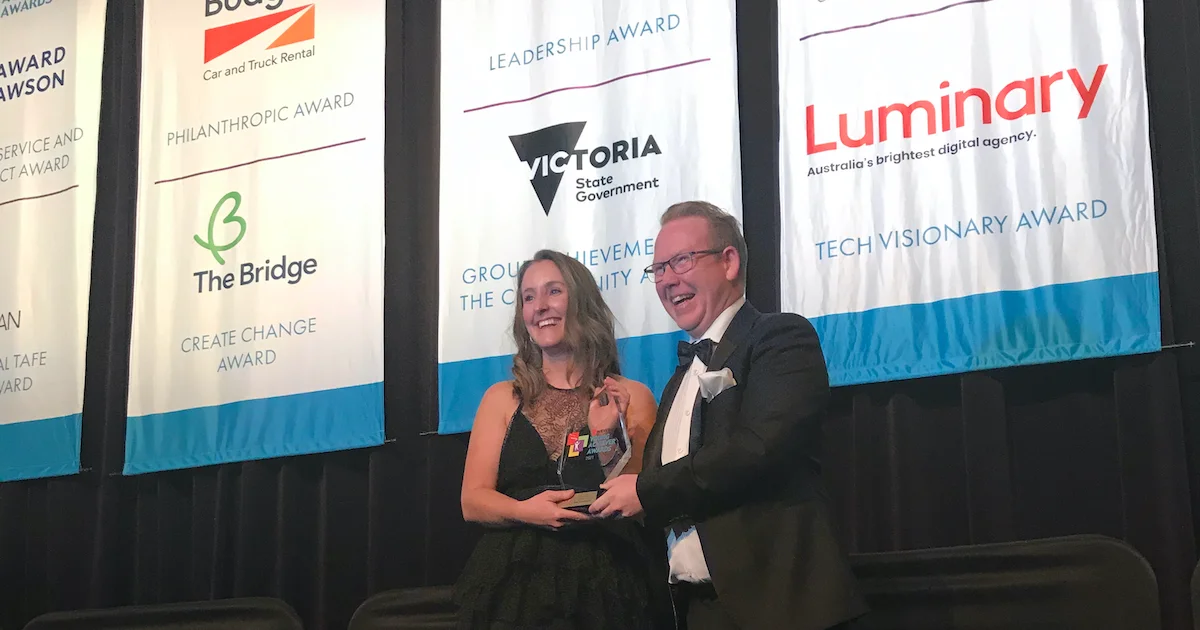 Woman founder smiling receiving award