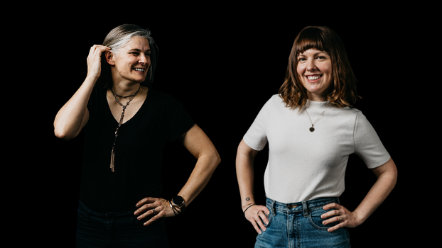Picture of Sarah and Grace standing against a black background