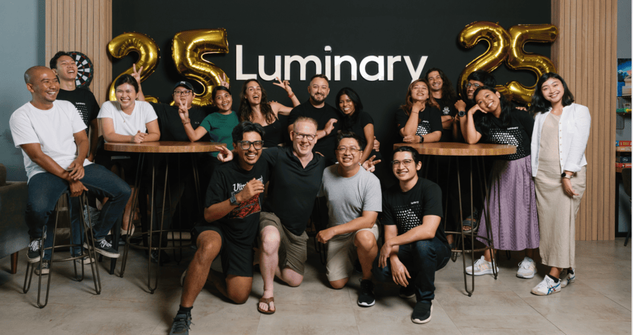 Indonesia team in Bali office, smiling with 25 number balloons behind