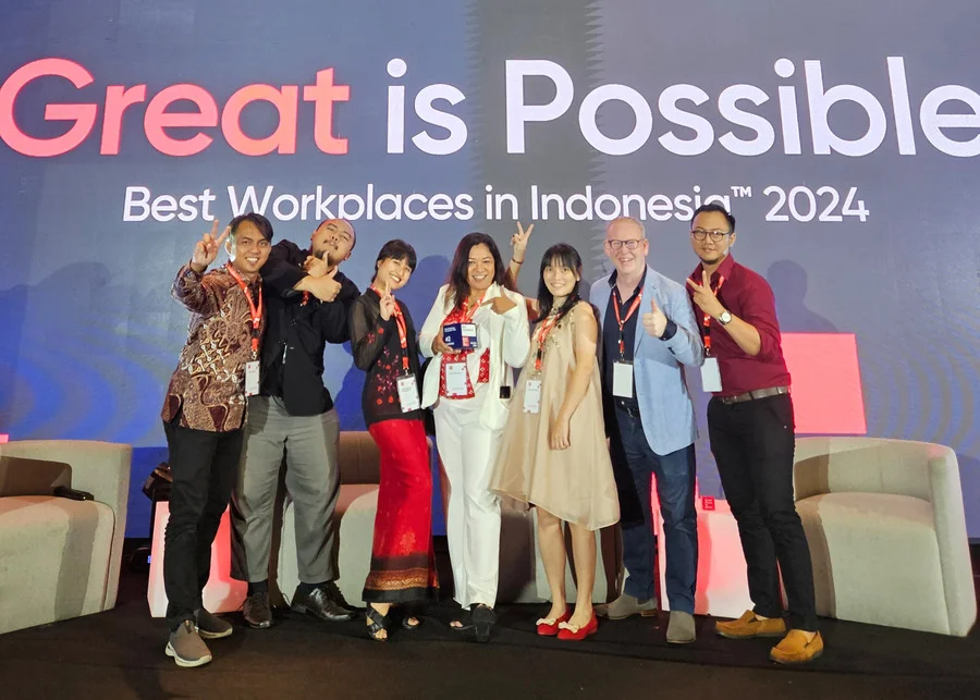 Indonesia team in front of Great Place to Work sign 