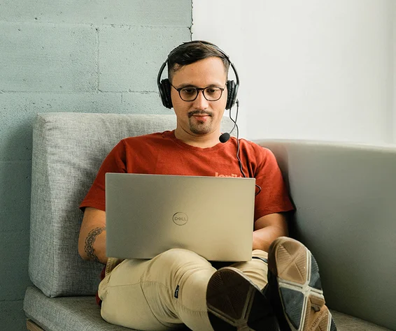 man working on a laptop on a couch