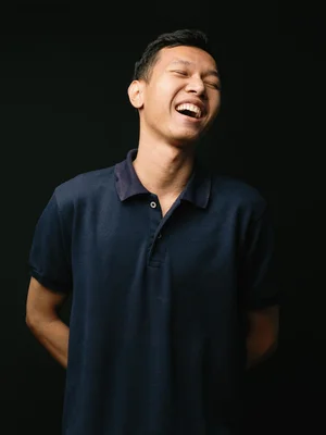 Picture of Artha laughing against a black background