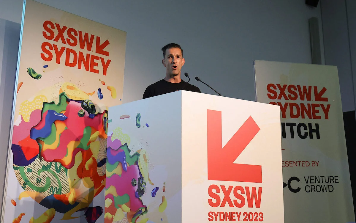 Picture of a man standing behind a SXSW Sydney branded podium.