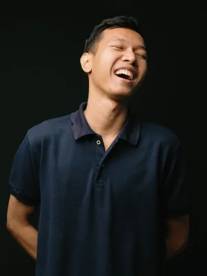 Picture of Artha laughing against a black background