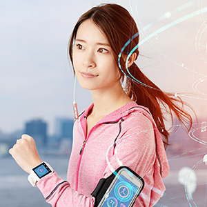 Woman exercising and using a cell phone and smart watch with health monitoring technology.