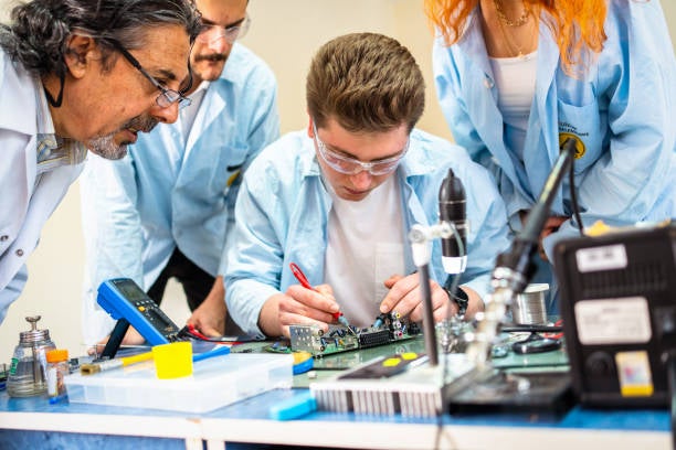 group of engineers working on a circuit