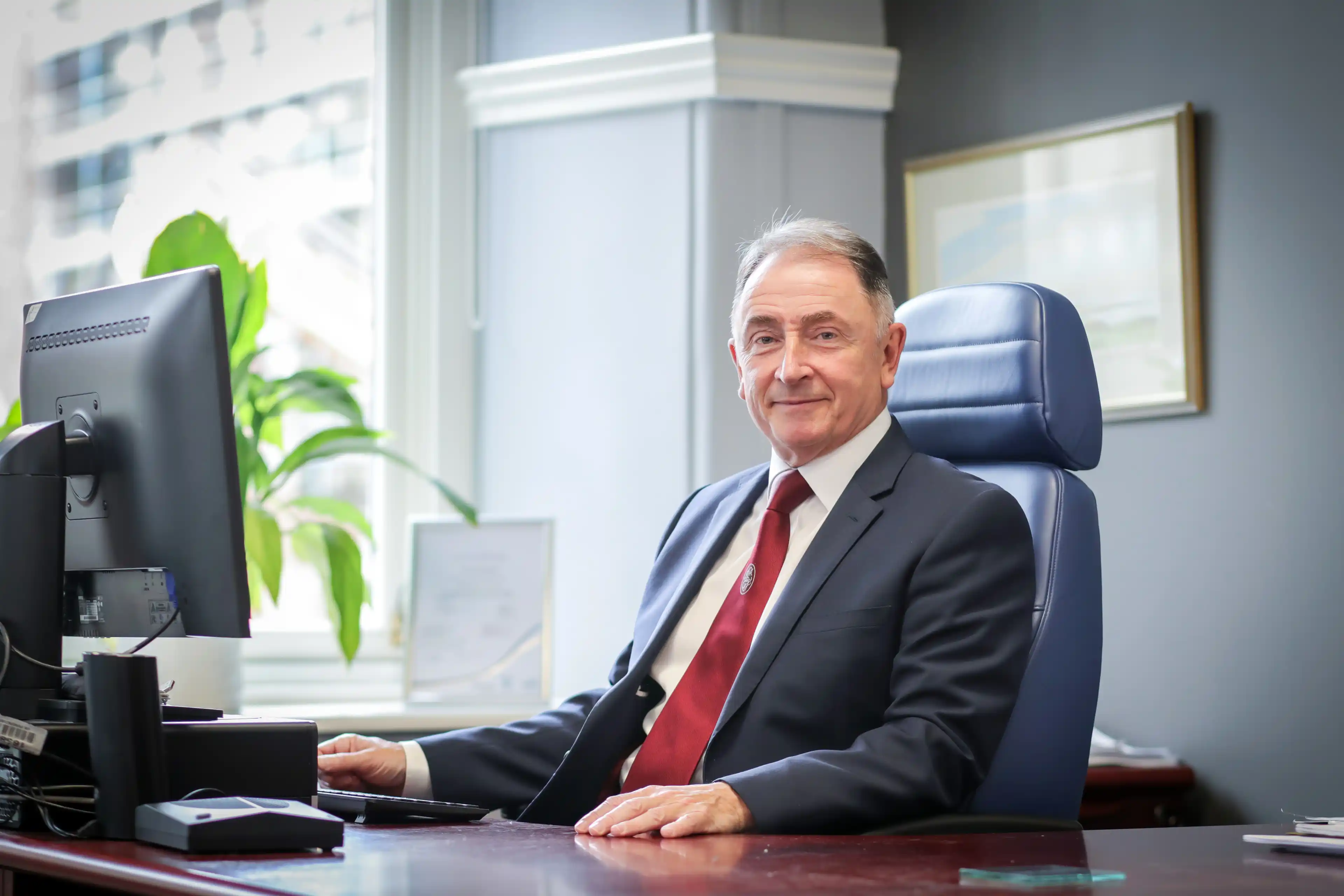 Sir Jim McDonald at a desk in front of a computer