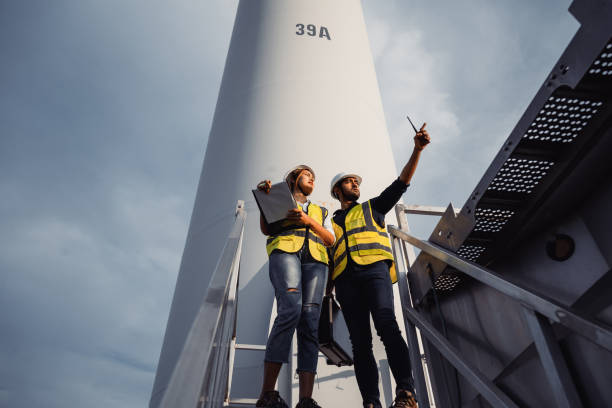 two engineers by a wind turbine