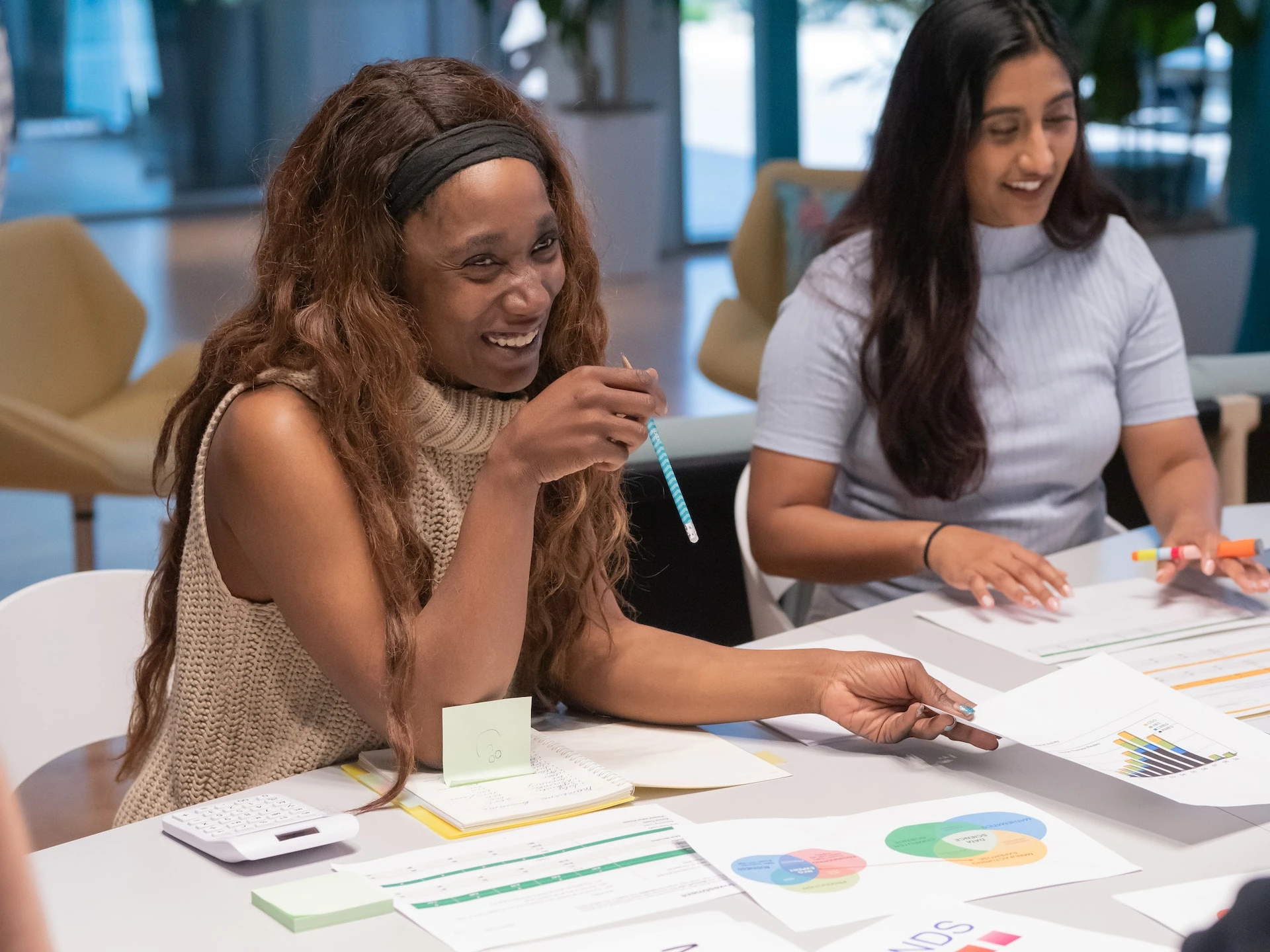 Laughing women collaborating in office