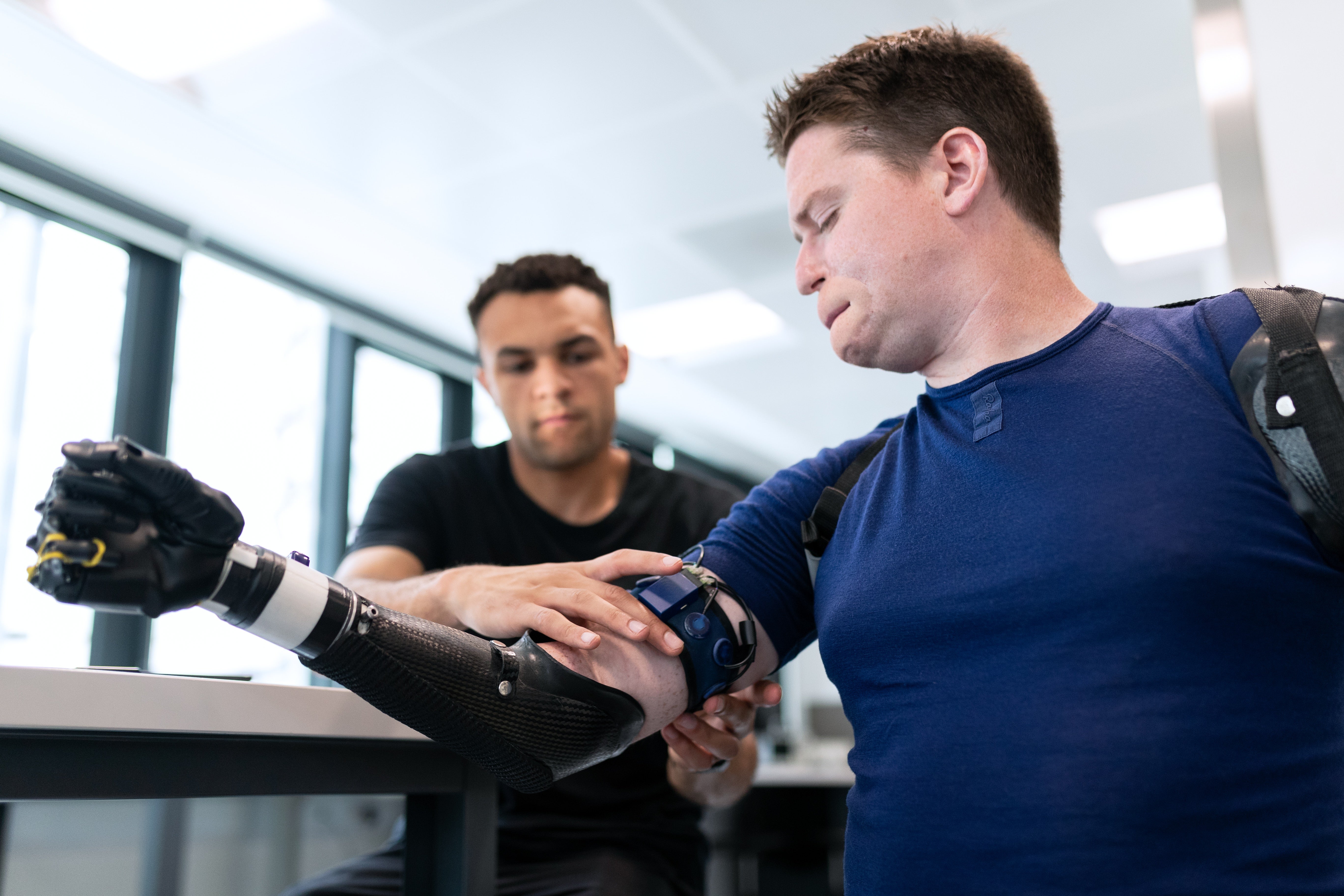 man being fitted with a prosthetic arm