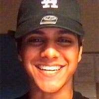 Student smiling in baseball cap