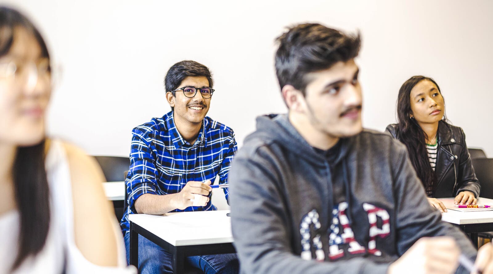 A smiling student in a Leeds ISC classroom.