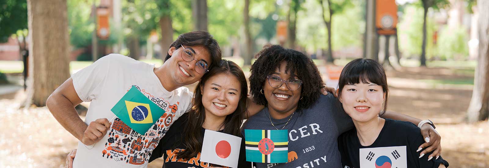 A group of international students holding small flags