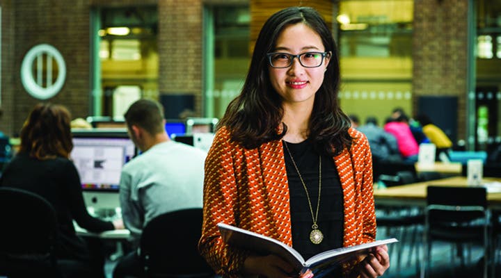 A Kingston University student in library