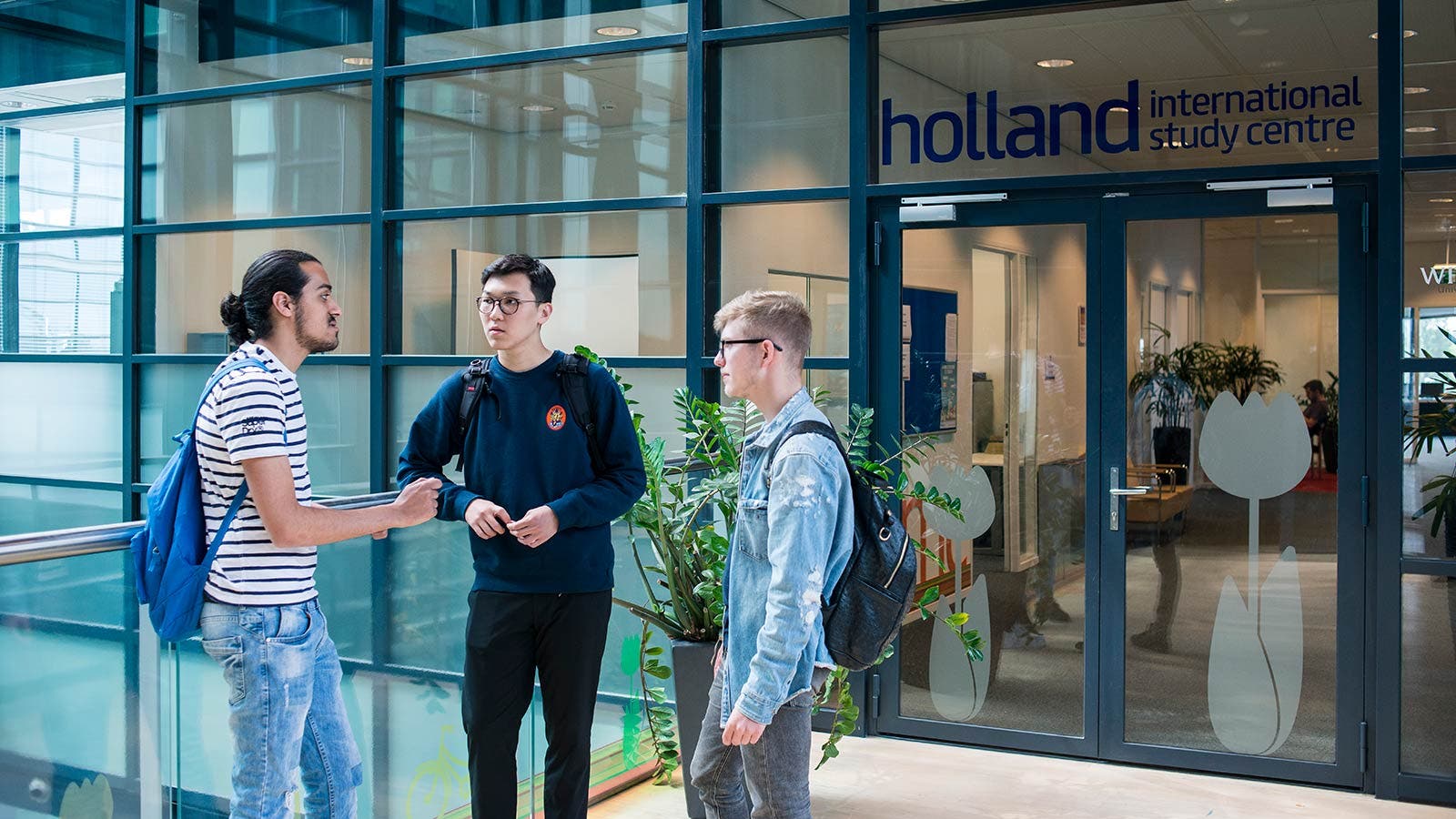 Three students outside Holland International Study Centre